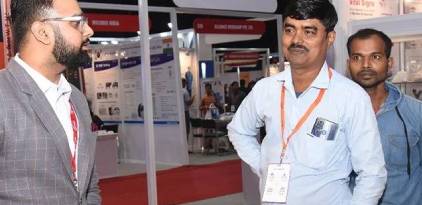 Praun Metal owner interacting with healthcare professionals at a medical gas pipeline system exhibition